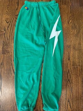 Aviator Nation Green Sweatpants with White Lightning Graphic